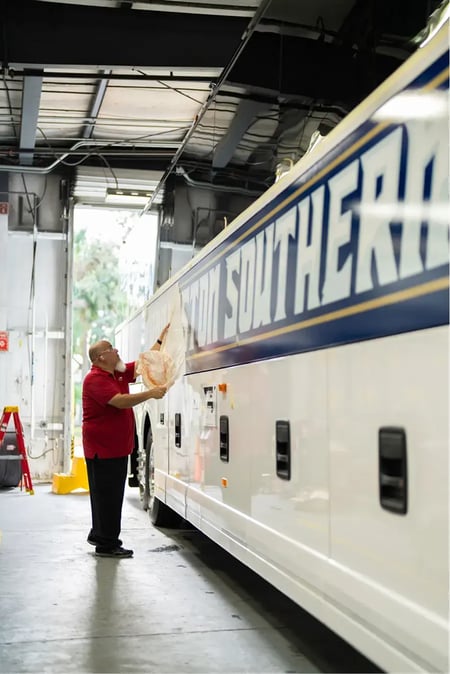 Bus wrap graphics being installed on motorcoach