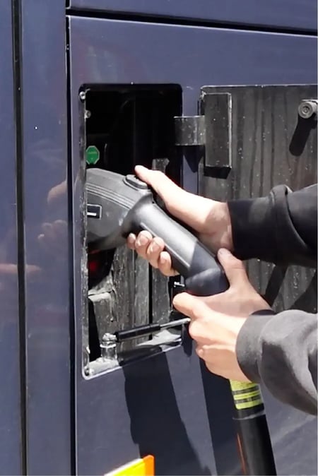 Bus driver refueling diesel motorcoach