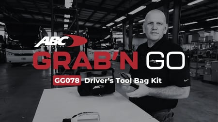 ABC Companies technician displaying essential motorcoach driver tools for pre-trip inspections and roadside troubleshooting