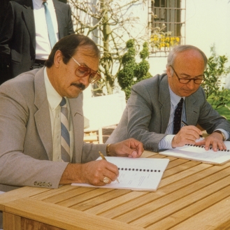 ABC Companies and Van Hool representatives signing their 1987 partnership to distribute Van Hool motorcoaches